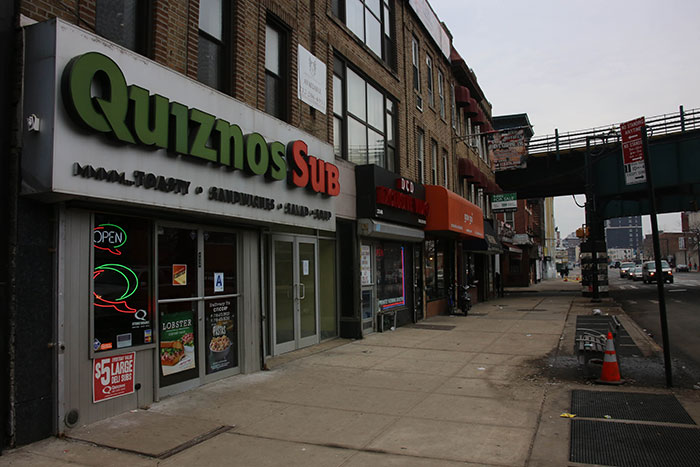 Street view of a Quiznos Sub storefront with faded signage, illustrating companies affected by a single bad decision.
