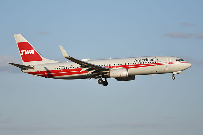 Airplane in mid-flight featuring classic TWA and American Airlines branding, symbolizing companies affected by bad decisions.