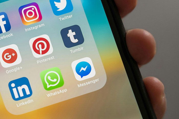 Smartphone screen showing social media apps including Instagram, Twitter, LinkedIn, WhatsApp, illustrating companies affected by bad decisions.