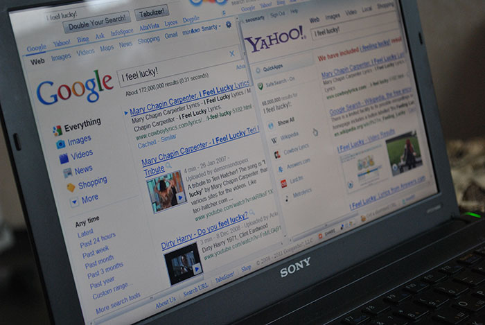 Laptop screen showing Google and Yahoo search results pages, illustrating companies impacted by a single bad decision.