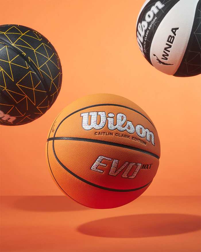 Wilson basketballs, including Caitlin Clark edition, against an orange background.