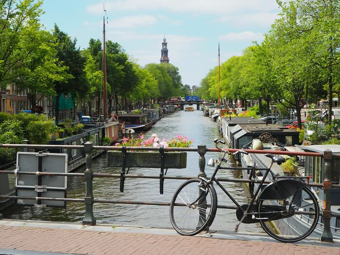 Bicycle by a scenic canal, reflecting life abroad for Americans who’ve moved permanently.