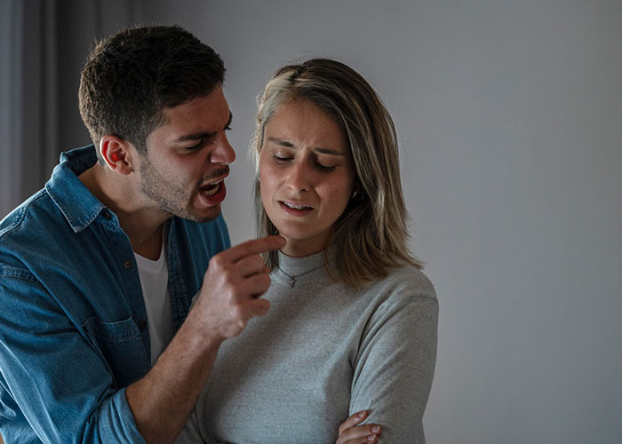 A couple arguing intensely, highlighting relationship issues related to cheating temptations.
