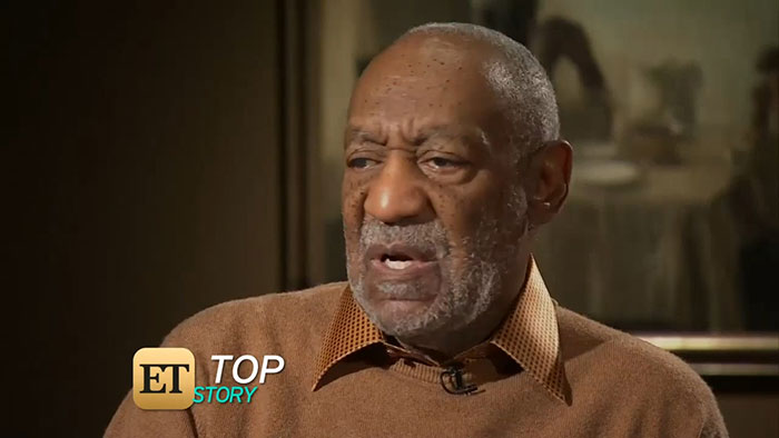 Elderly man in a brown sweater speaking during an interview on ET Top Story, discussing issues related to talented people.