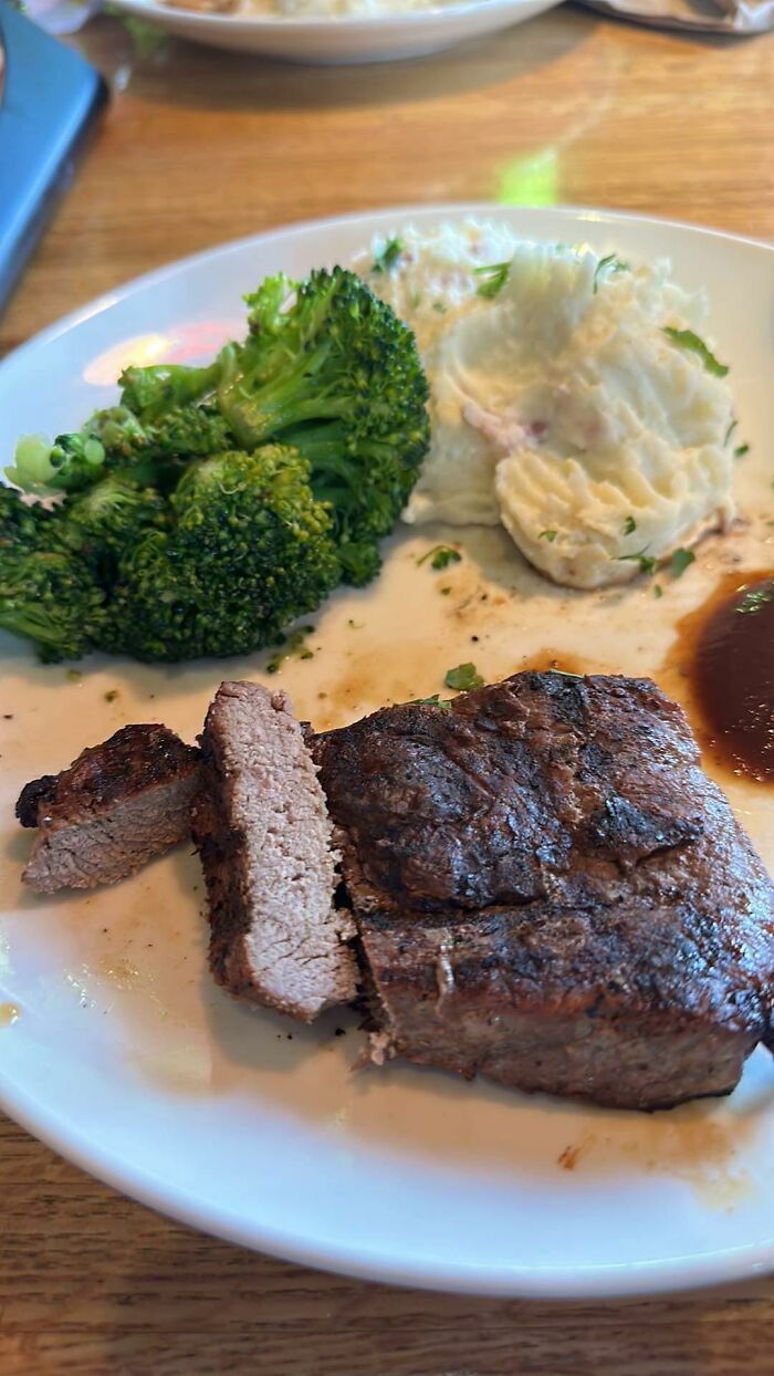 Plate with steak, mashed potatoes, and broccoli, typical chain restaurant meal.