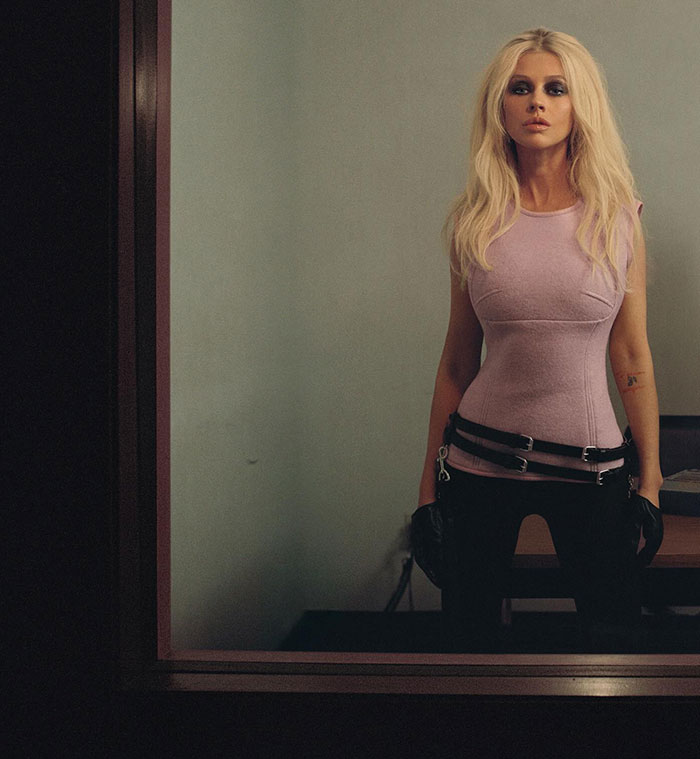 Christina Aguilera posing in a sleeveless top and gloves during a photoshoot sparking fans' claims of heavy photoshopping.