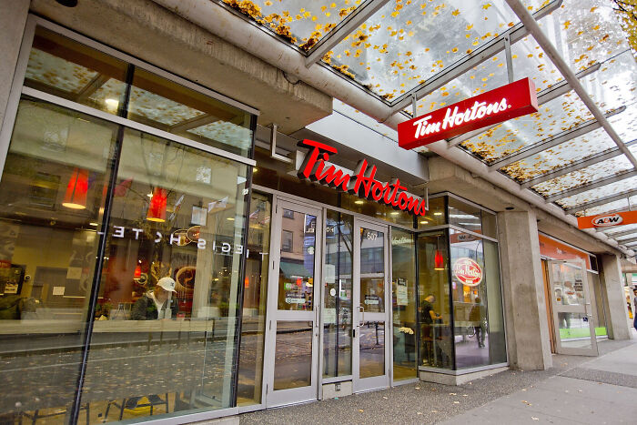 Tim Hortons storefront with glass facade, highlighting brand loyalty discussion.