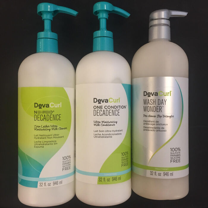 Three DevaCurl hair care bottles with pumps, highlighting sulfate and paraben free products, symbolizing companies that lost customers.