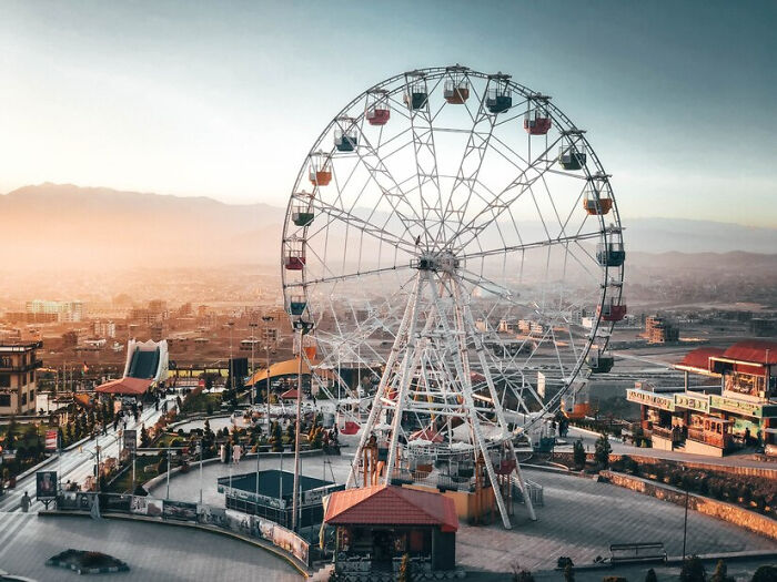 Ferris wheel at sunset, offering a scenic view of the city, highlighting small things in life.