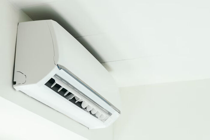 Wall-mounted air conditioner in a room, illustrating small things saving lives unexpectedly.