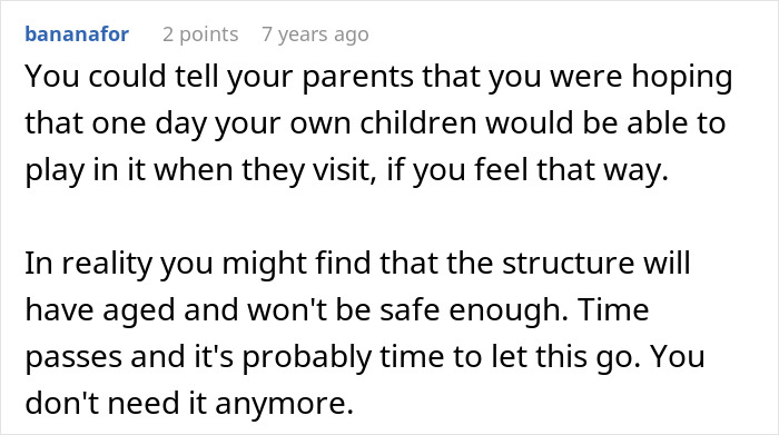 Sad daughter standing near a childhood tree house, reflecting on memories with a somber expression outdoors.