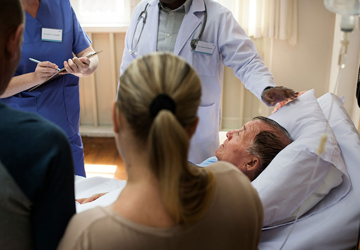 Medical staff attending to a patient, illustrating a care-focused work perk in a supportive company environment.