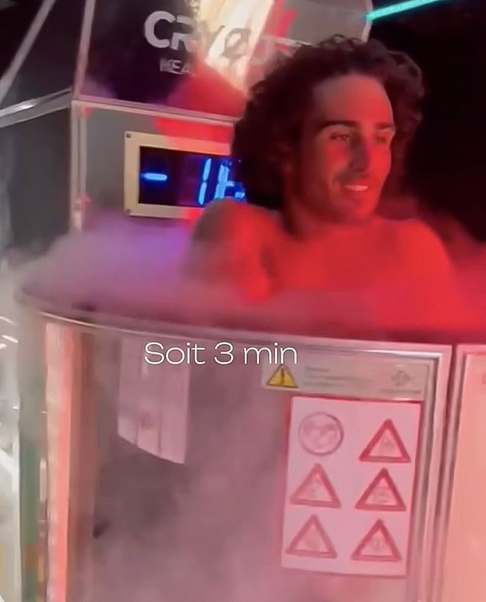 Man in cryotherapy chamber with visible caution signs, highlighting treatment dangers. Man in cryotherapy chamber with visible caution signs, highlighting treatment dangers.