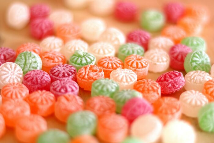 Close-up of colorful candies scattered on a surface representing unfair treatment from doctors affecting women.