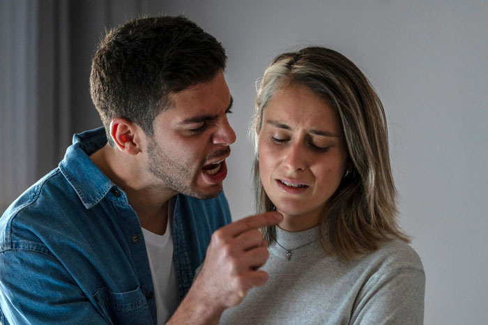Couple arguing indoors, man angrily pointing finger at woman who looks upset, highlighting family conflict over lifestyle. Couple arguing indoors, man angrily pointing finger at woman who looks upset, highlighting family conflict over lifestyle.