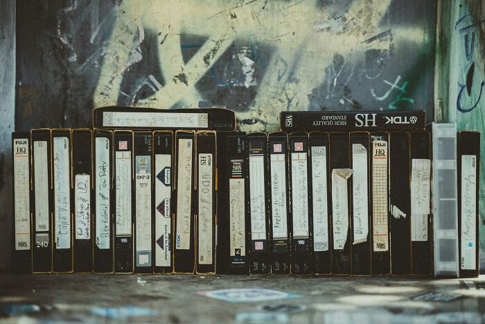 VHS tapes on a shelf, reminiscent of nostalgic activities from 30 years ago.