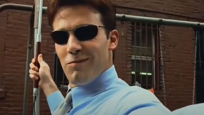 Man in sunglasses and a blue shirt on a film set, linked to Hollywood casting mistakes.