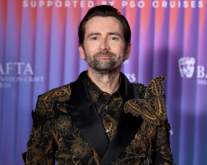 David Tennant in an ornate black and gold outfit at a BAFTA event, addressing trans allyship.
