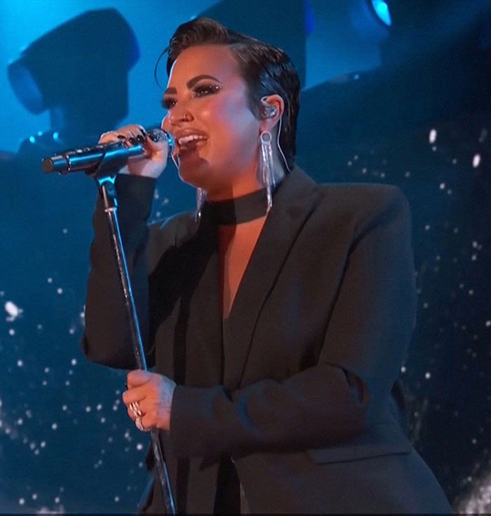 Singer performing on stage, sparking Ozempic accusations due to a notably slimmer appearance.