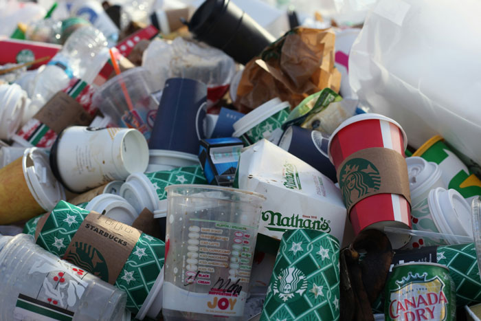 A pile of discarded coffee cups and fast-food containers highlighting America's dirtiest cities issue. A pile of discarded coffee cups and fast-food containers highlighting America's dirtiest cities issue.