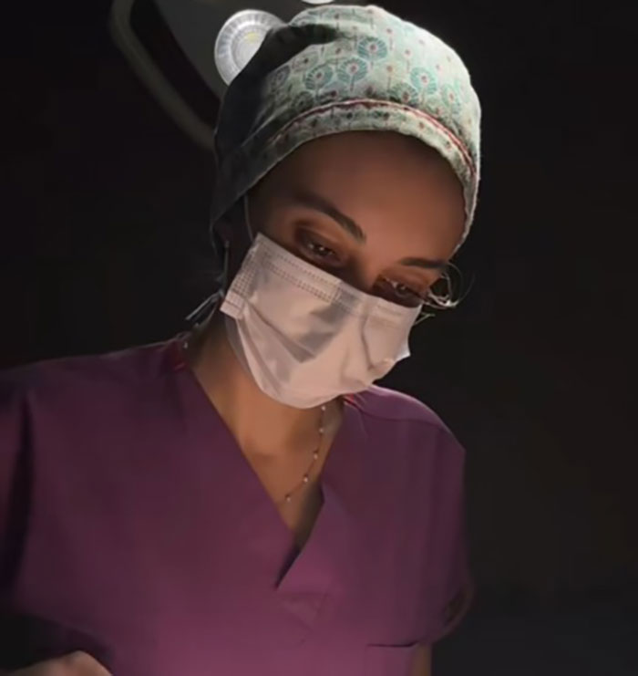 Surgeon in a mask and scrubs under operating light, highlighting botched nose job concerns.
