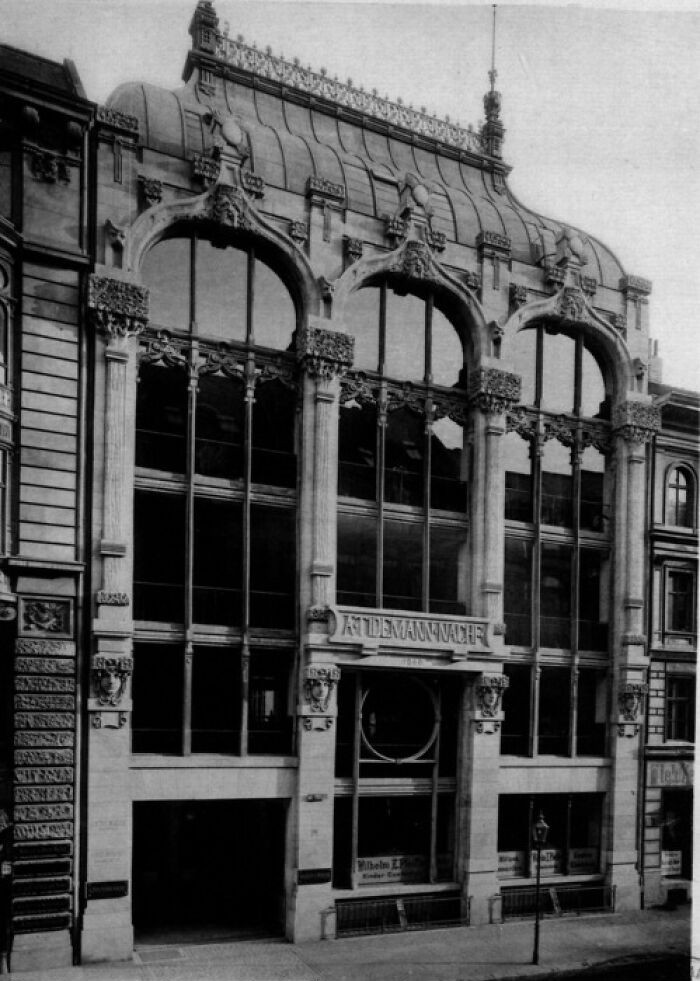 Historic European architecture featuring large arched windows and detailed stonework from life in Europe 100 years ago