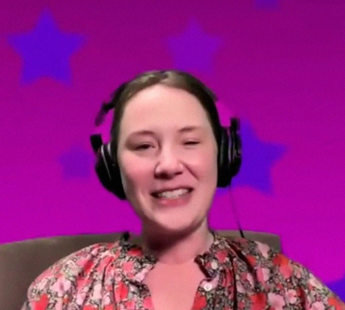 A woman with headphones and a floral shirt against a pink background with stars discusses her childhood experiences.