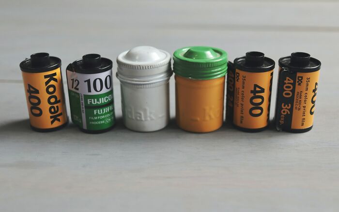 Film canisters, resembling items doctors might disturbingly find in patients, lined up on a light surface.