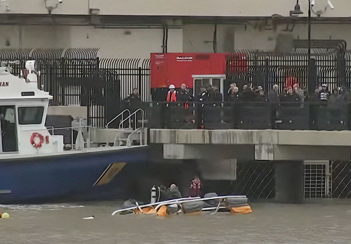 Helicopter submerged in New York river as rescue team responds to accident scene.