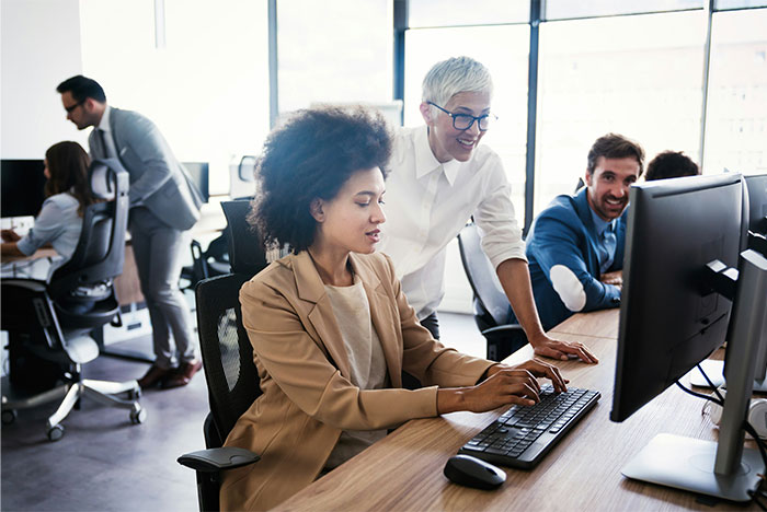 Employees collaborating in a modern office, discussing confidential workplace insights.