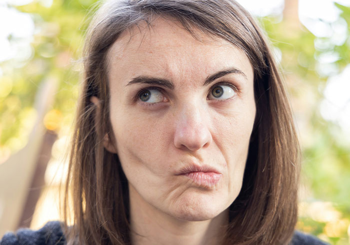 Woman pondering decision about sister, Easter vacation conflict.