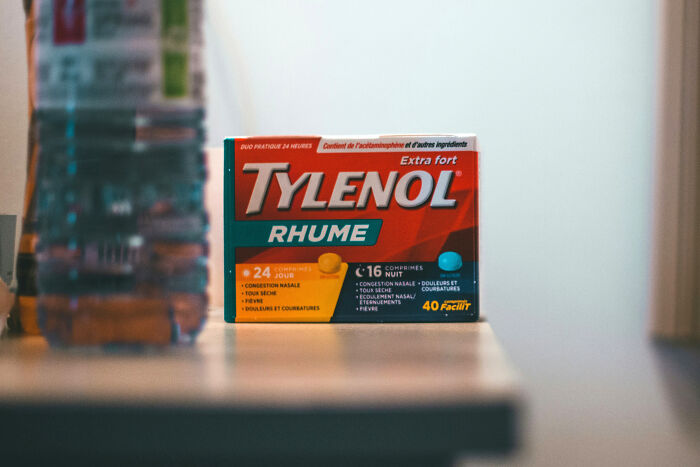 "Tylenol cold medicine box on a table, highlighting its everyday appearance yet potential dangers."