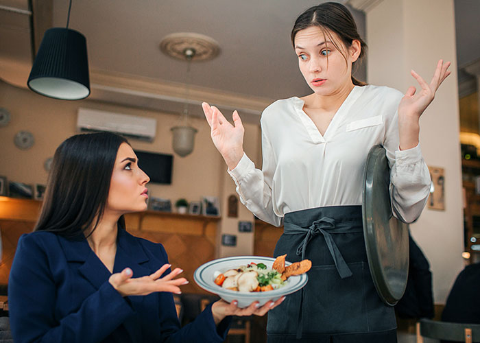Server and customer in European cafe miscommunicating, highlighting cultural differences.