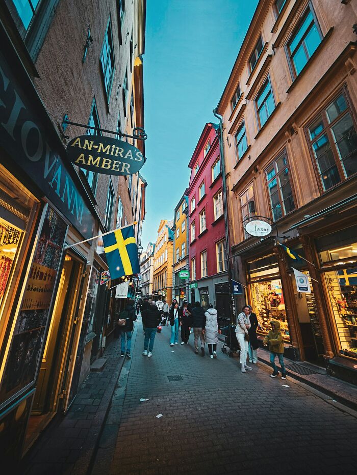 Crowded street in Sweden with colorful buildings, symbolizing Americans moving abroad permanently for a new life.