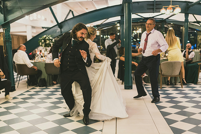 Bride and guests dancing happily at a wedding reception, capturing joyful moments and upset-free celebration.