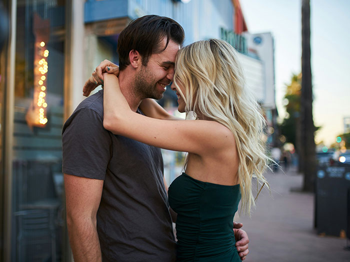 A couple embraces on a city street, symbolizing trust and relationships before potential betrayal. A couple embraces on a city street, symbolizing trust and relationships before potential betrayal.