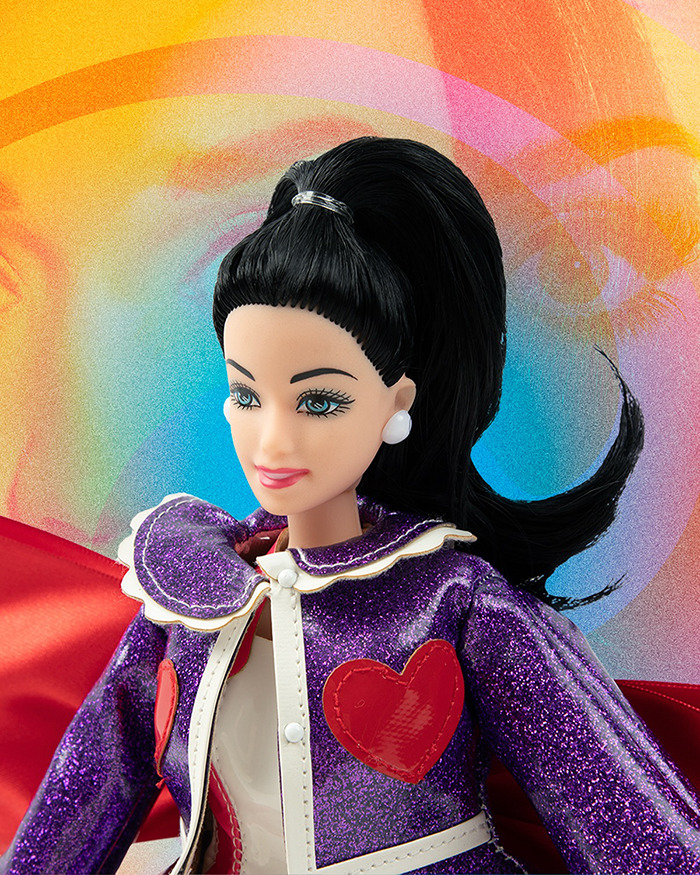 Limited edition doll in purple glitter outfit with red heart, inspired by singer's recent space flight event. Limited edition doll in purple glitter outfit with red heart, inspired by singer's recent space flight event.