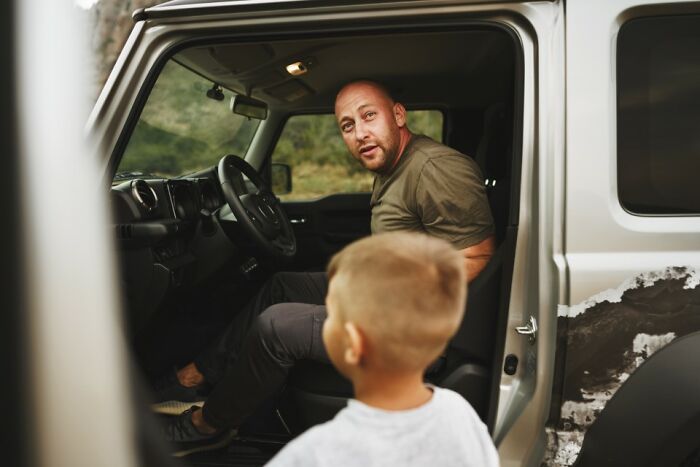 A man in a car engages with a child, highlighting accidental comedy moments with children.