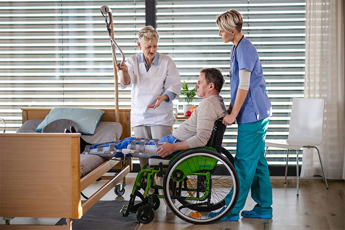 Woman in wheelchair receiving medical care for physical consequences after an accident caused by her fiancé. Woman in wheelchair receiving medical care for physical consequences after an accident caused by her fiancé.