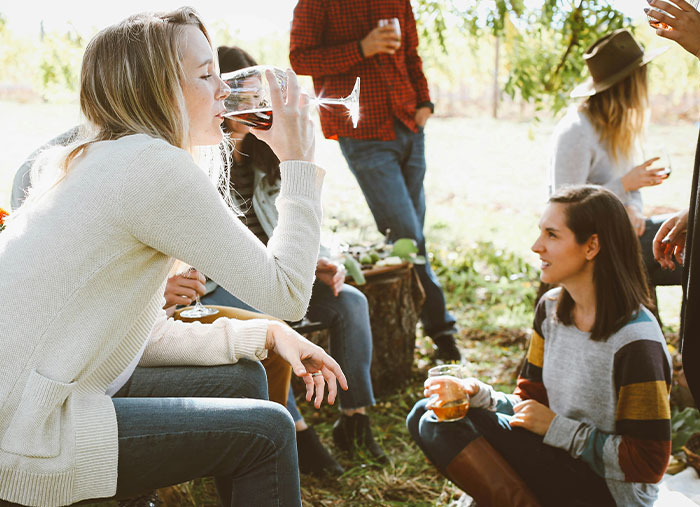 Group of friends enjoying drinks outdoors, highlighting friendships.