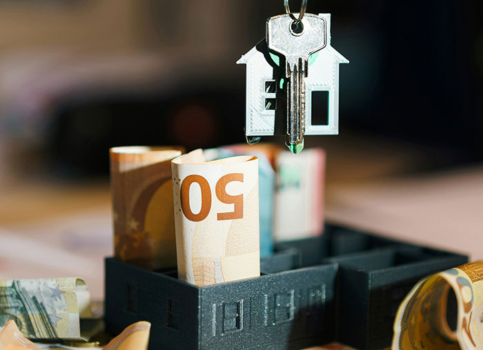 Money and house key representing changes in friendships.