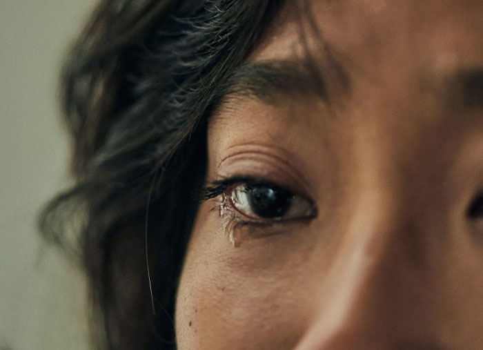 Close-up of a person's eye with a tear, reflecting on ending great friendships.