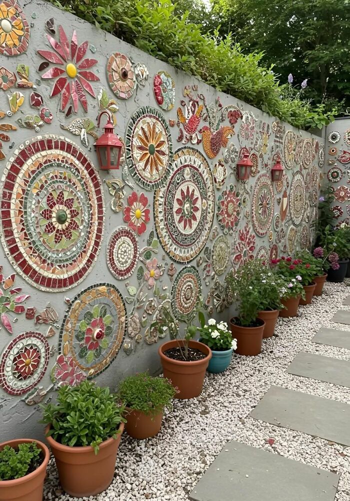 Wall with colorful mosaic art and flower pots, showcasing forbiddingly beautiful stories from around the world.
