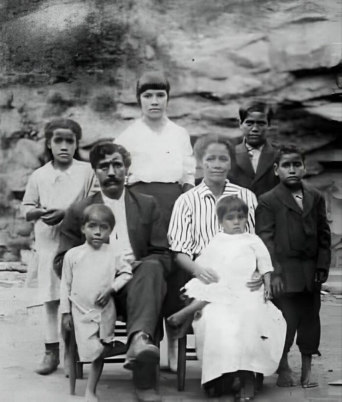 Vintage family portrait in a natural setting, showcasing a unique moment for "Forbidden Stories."