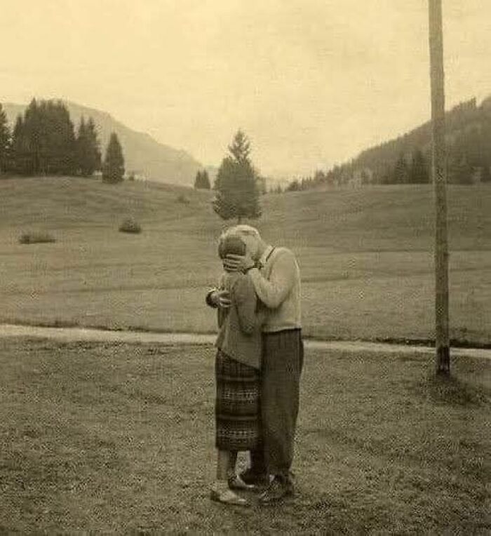 Elderly couple embracing in a scenic landscape, illustrating a forbidden story of timeless love.