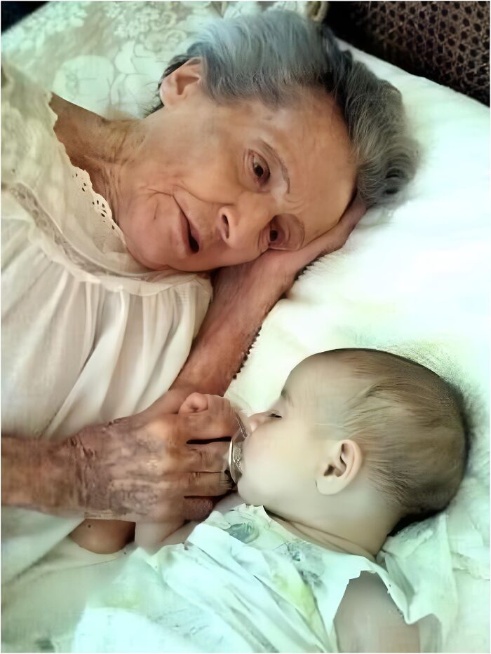Elderly woman tenderly holding a sleeping baby, symbolizing a touching moment across generations.
