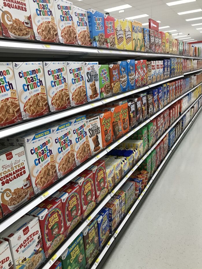 A grocery aisle filled with a wide variety of cereal boxes, highlighting a culture shock in the USA.