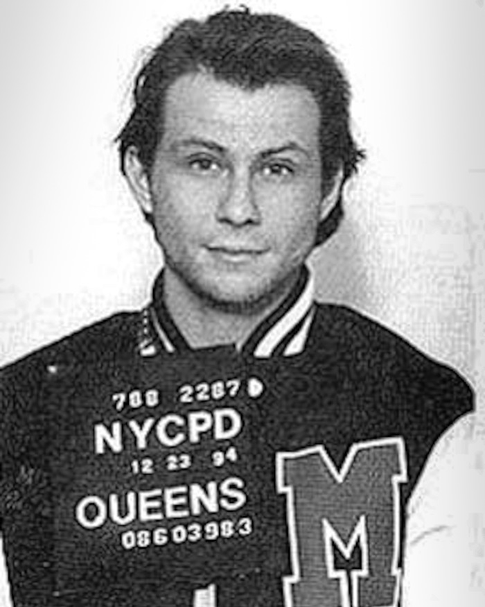 Black and white mugshot of a young man wearing a letterman jacket, linked to forgotten Hollywood scandals.