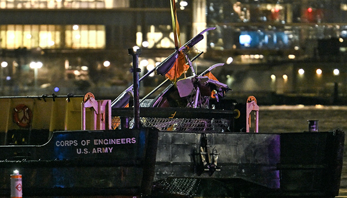 Helicopter wreckage on a U.S. Army Corps of Engineers boat at night, possibly explaining the crash.
