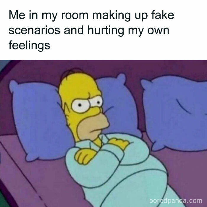 Homer Simpson lying in bed with arms crossed, illustrating anxiety with a frustrated expression in a silly anxiety meme.